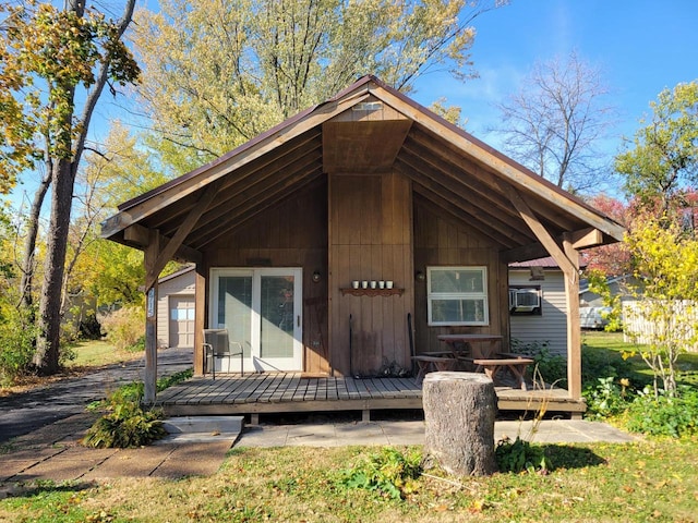 rear view of house featuring a wooden deck