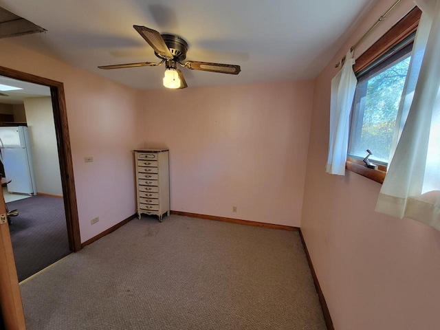 spare room featuring light colored carpet and ceiling fan