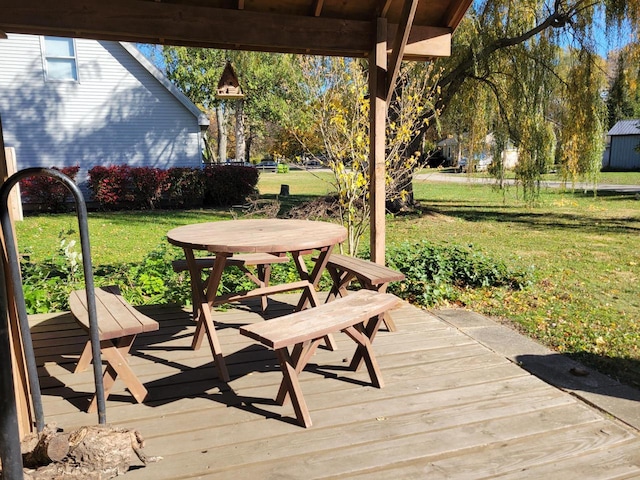 wooden terrace featuring a lawn