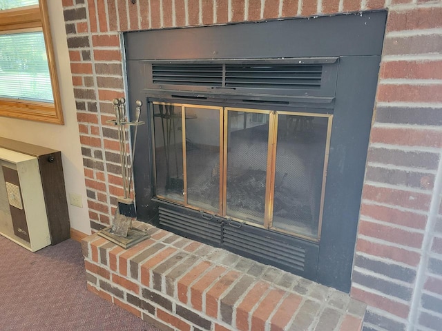 interior details featuring carpet flooring and a fireplace