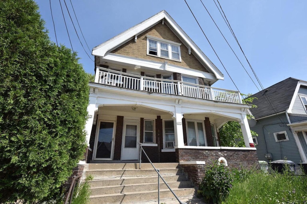 view of front of house featuring covered porch and a balcony