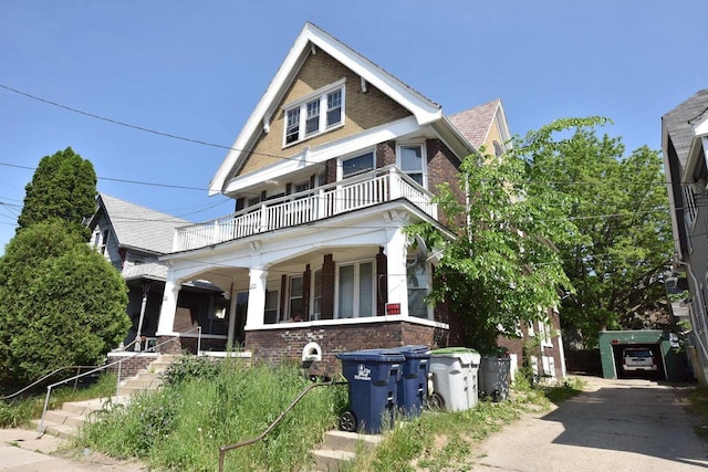 view of front of home with a balcony and covered porch