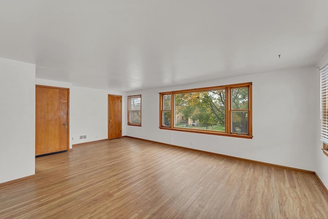 unfurnished room with light hardwood / wood-style flooring