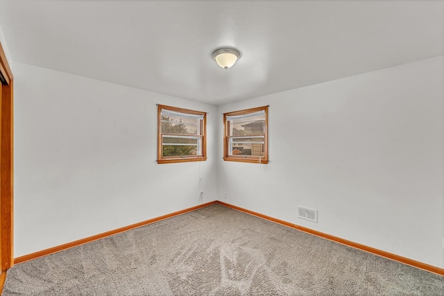 unfurnished room featuring carpet