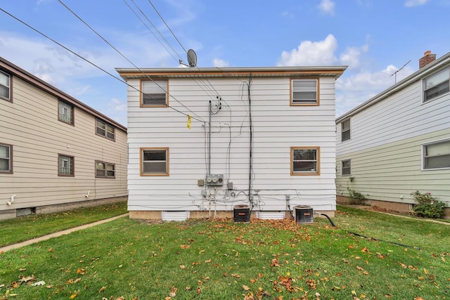 rear view of property featuring a lawn