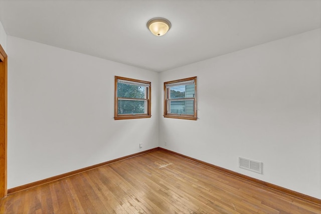 unfurnished room with light wood-type flooring