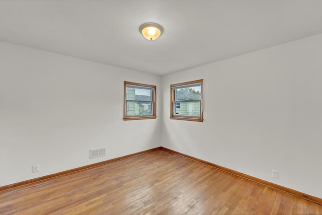 unfurnished room featuring hardwood / wood-style flooring