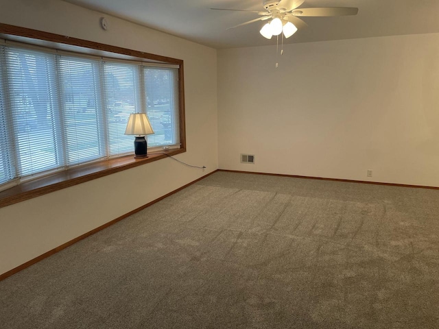 empty room featuring carpet flooring and ceiling fan