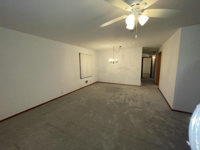 spare room with carpet flooring and ceiling fan with notable chandelier