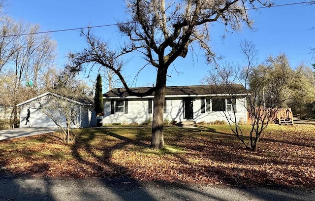 single story home featuring a garage and a front lawn