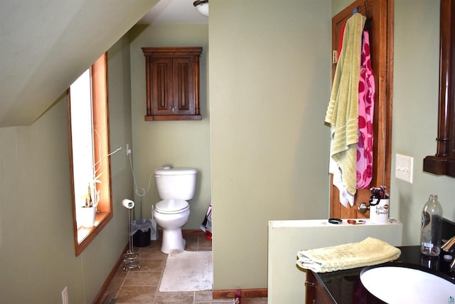 bathroom featuring tile patterned flooring, vanity, and toilet