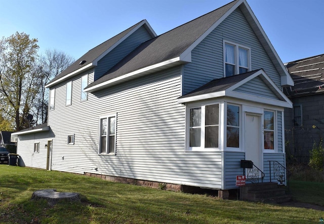 view of home's exterior with a yard