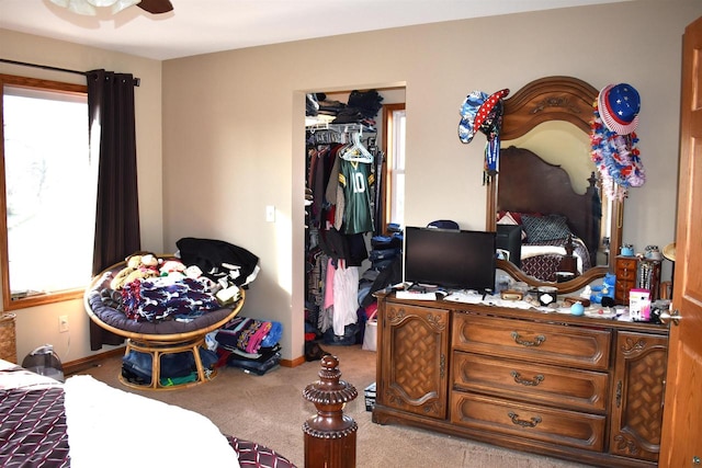 carpeted bedroom with ceiling fan and a closet