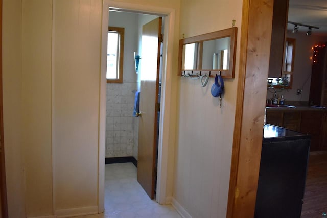 hallway with sink and track lighting