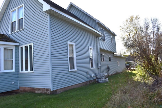 view of property exterior with a lawn