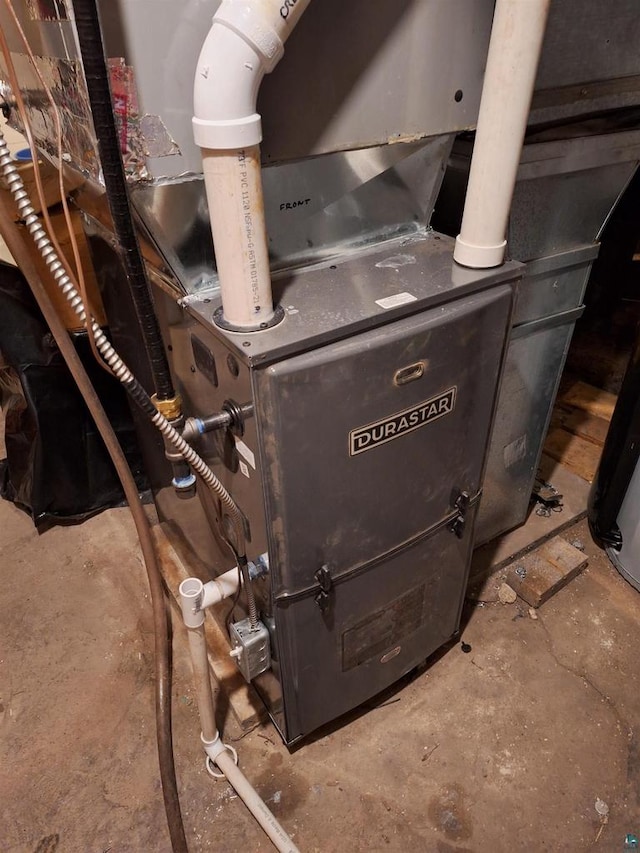 utility room featuring heating unit