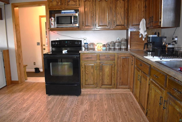 kitchen with light hardwood / wood-style floors and electric range