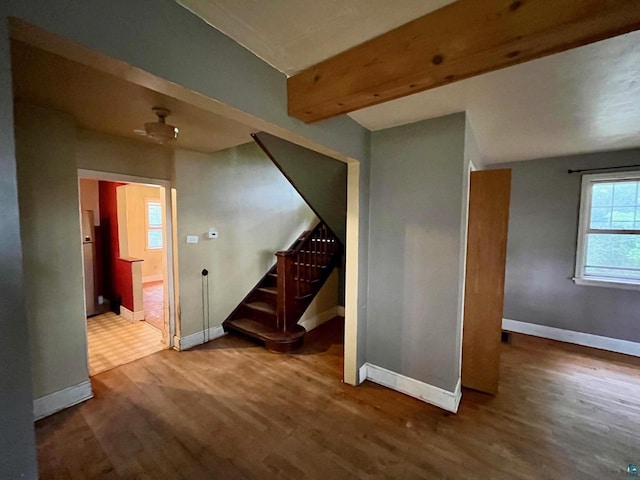 interior space with beamed ceiling and hardwood / wood-style floors