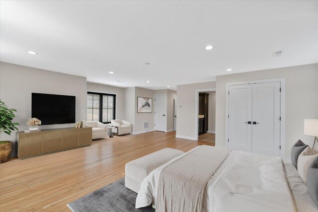 bedroom featuring baseboards, visible vents, wood finished floors, and recessed lighting