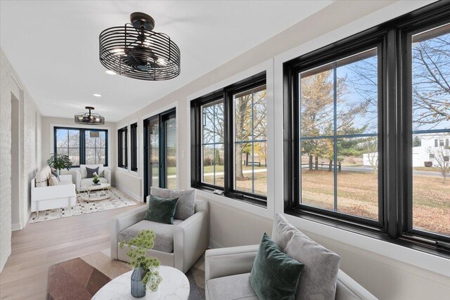 sunroom with an inviting chandelier