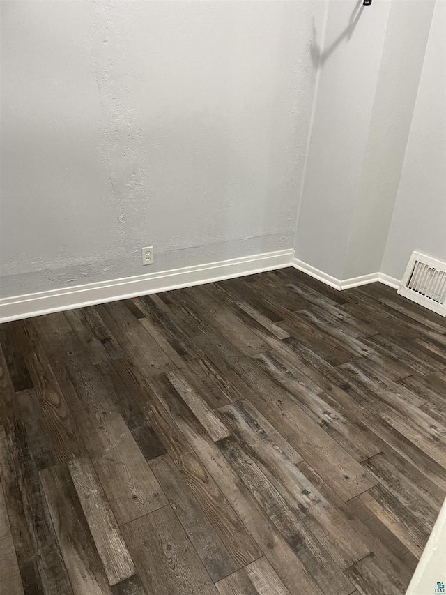 spare room featuring dark hardwood / wood-style flooring