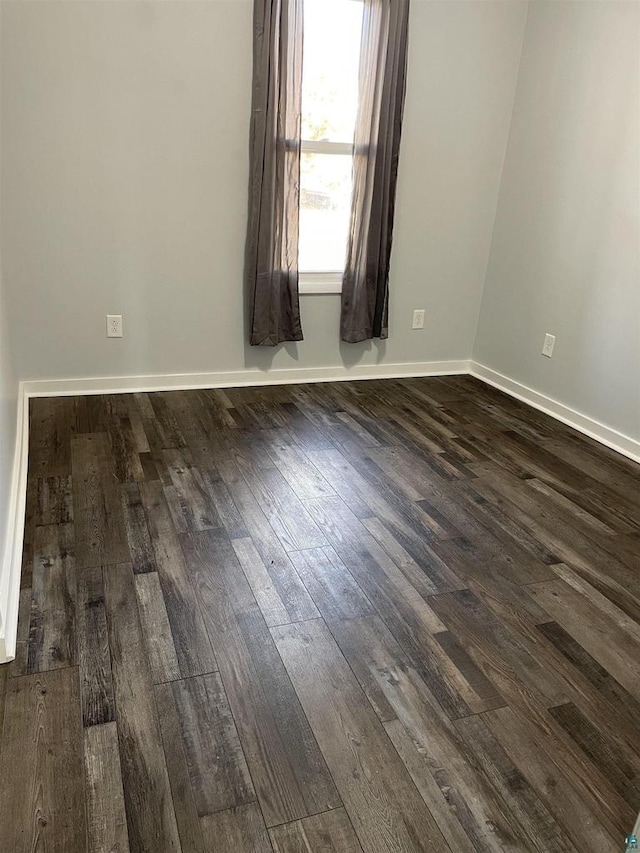 unfurnished room featuring dark wood-type flooring