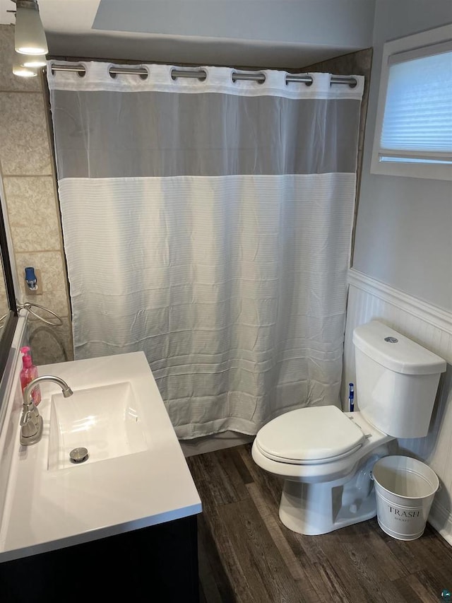 bathroom featuring vanity, toilet, wood-type flooring, and curtained shower