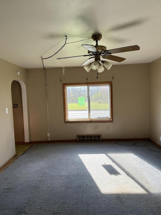 empty room featuring carpet flooring and ceiling fan