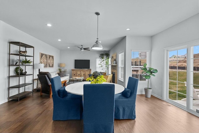 dining room featuring ceiling fan, plenty of natural light, and dark hardwood / wood-style floors