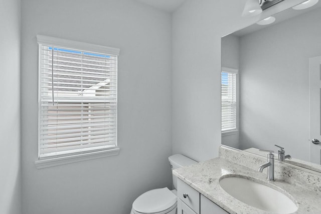 bathroom with toilet and vanity