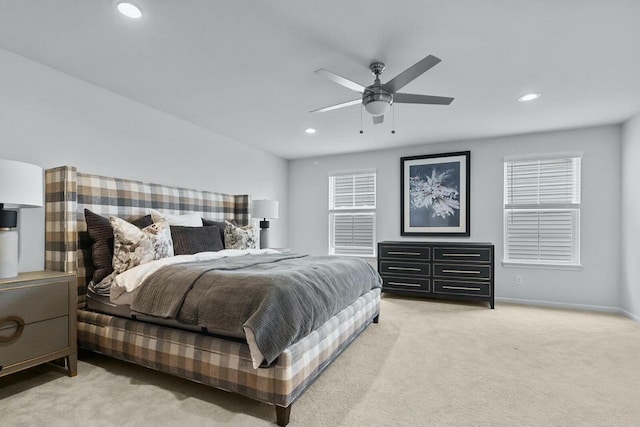 carpeted bedroom with multiple windows and ceiling fan