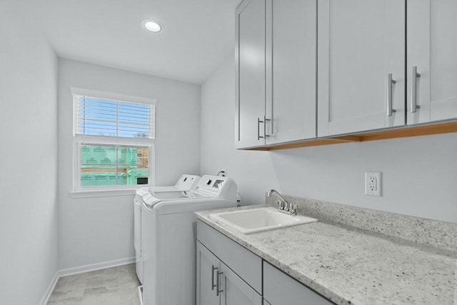 washroom with cabinets, sink, and separate washer and dryer