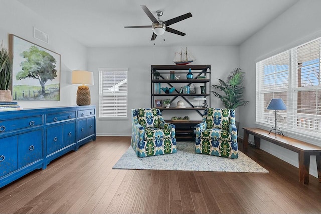 living area with light hardwood / wood-style floors and ceiling fan