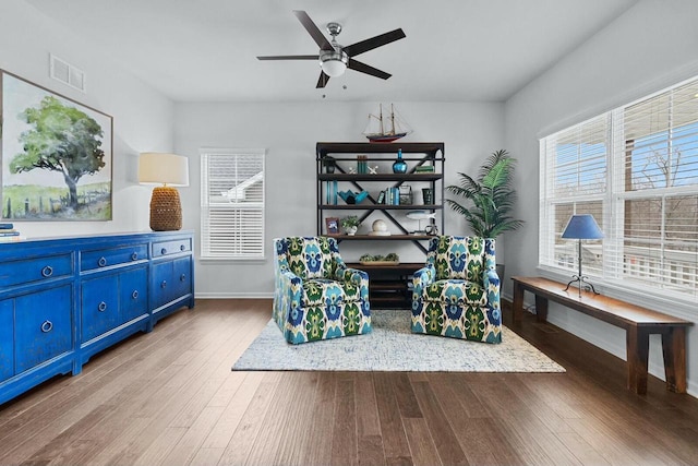 living area with light hardwood / wood-style floors and ceiling fan