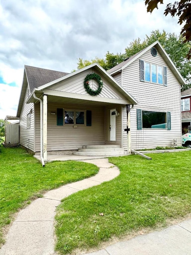 view of front facade with a front yard and covered porch