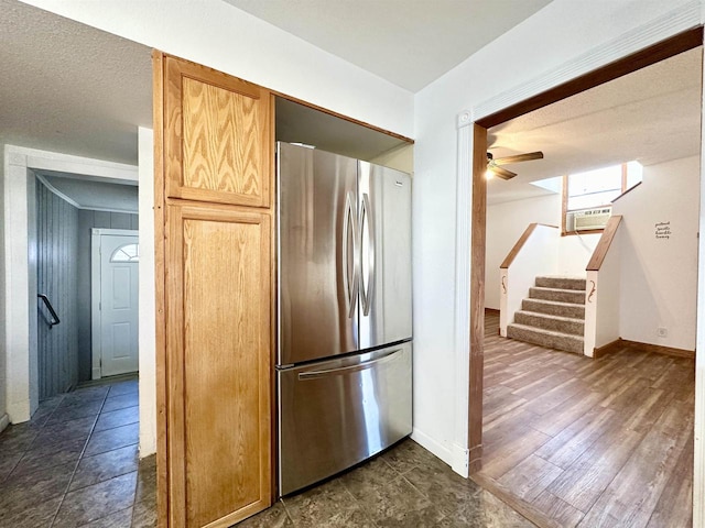 kitchen with dark wood-type flooring, ceiling fan, a textured ceiling, and stainless steel fridge