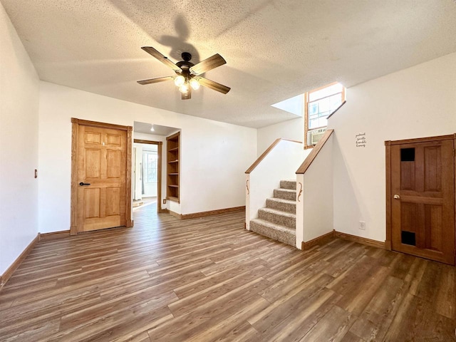 spare room featuring a textured ceiling, ceiling fan, and dark hardwood / wood-style flooring