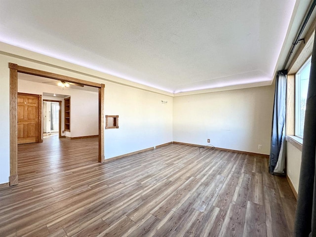 spare room with hardwood / wood-style floors and a textured ceiling