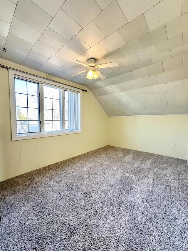 additional living space with ceiling fan, carpet, and vaulted ceiling