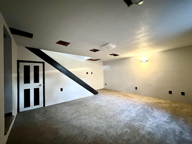 carpeted spare room featuring a textured ceiling