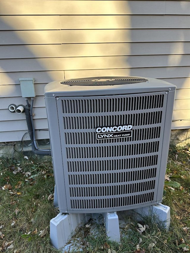 details featuring central air condition unit and wood walls