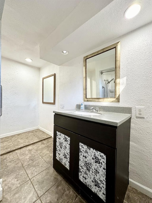 bathroom with vanity, tile patterned floors, and a textured ceiling