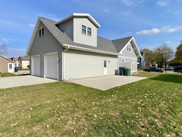 view of side of property featuring a yard and a garage