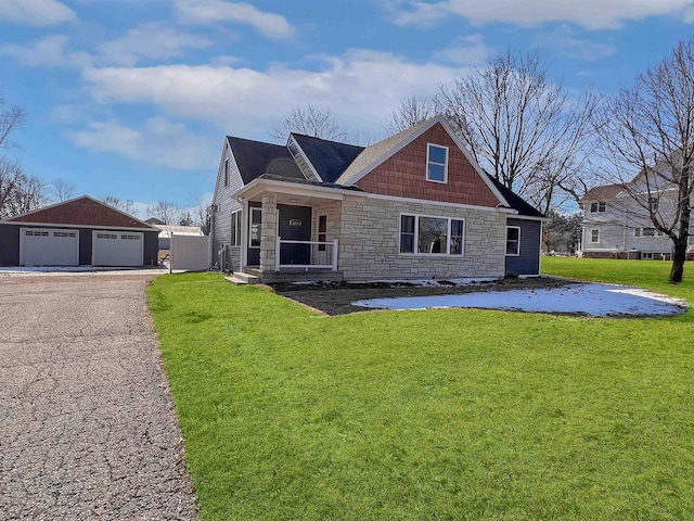 view of front of house featuring an outdoor structure, a front lawn, and a garage