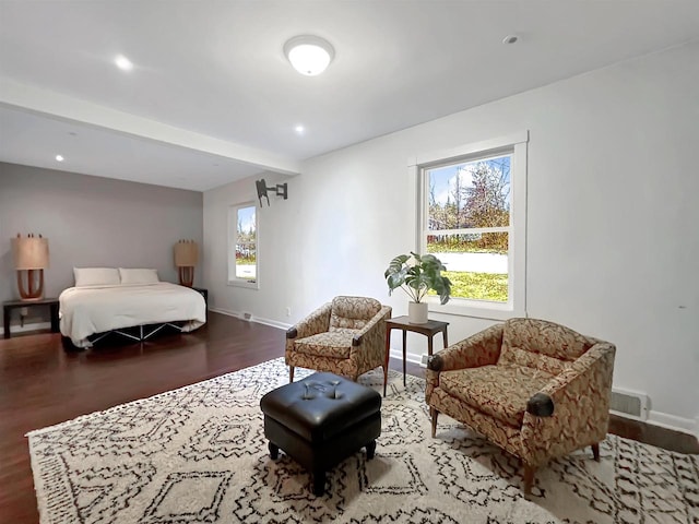 bedroom featuring multiple windows and hardwood / wood-style floors