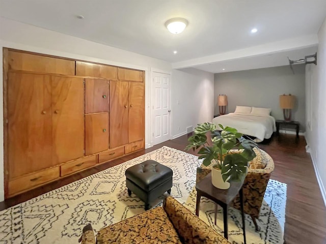 bedroom with dark hardwood / wood-style floors and a closet