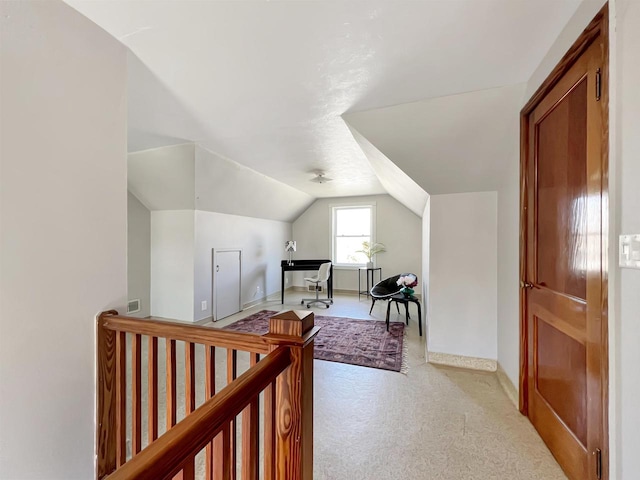 bonus room with lofted ceiling and light carpet