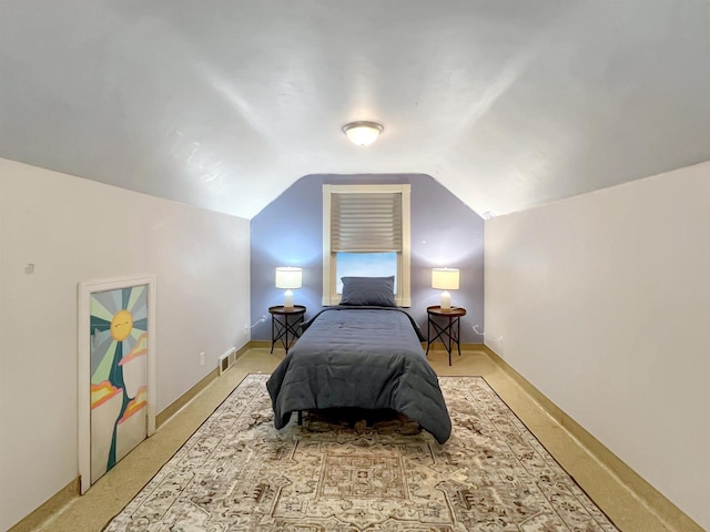 carpeted bedroom featuring lofted ceiling