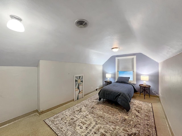 carpeted bedroom with vaulted ceiling