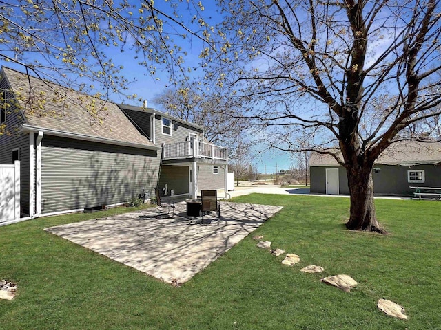 view of yard featuring a patio, a shed, and a balcony